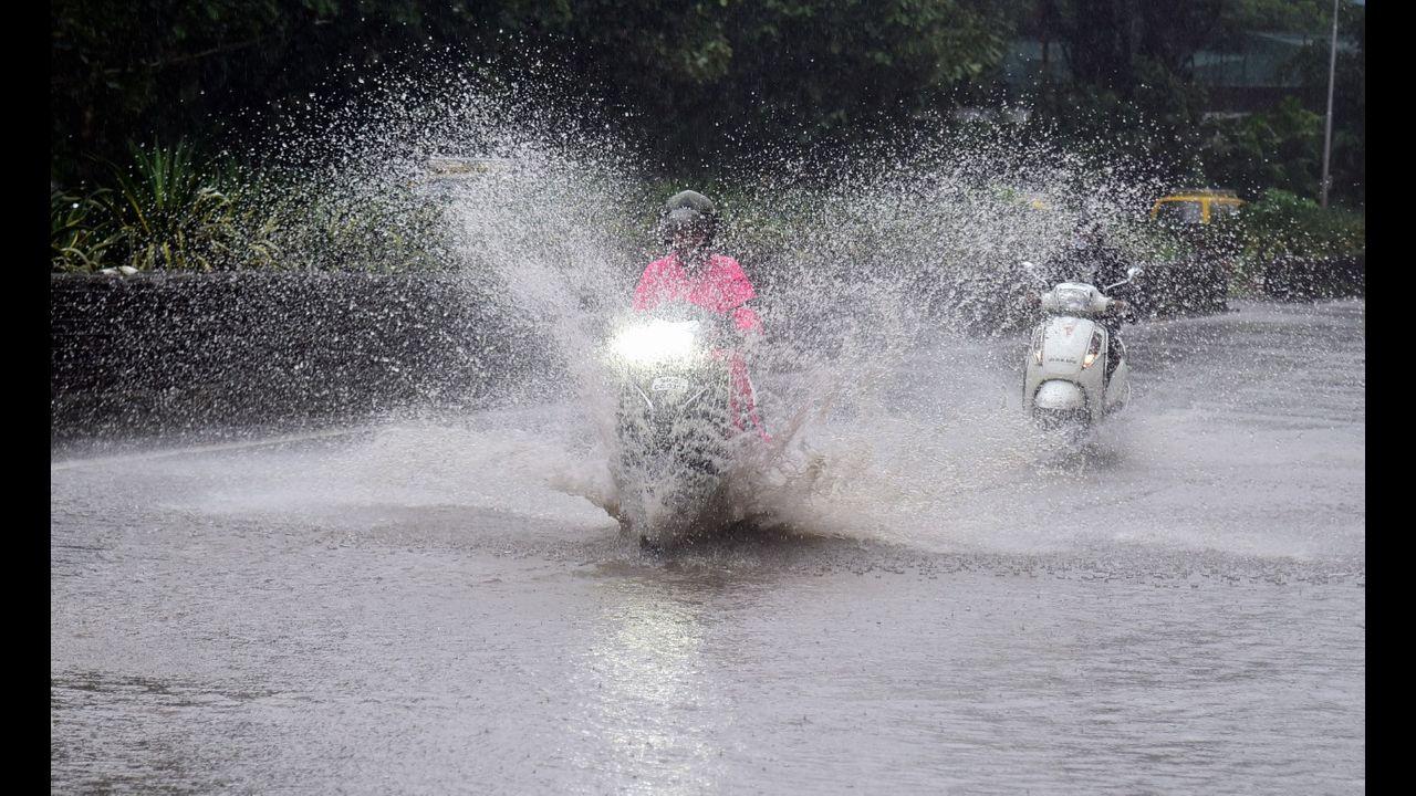 Vehicle wade through water logged road during heavy rain at Wadala in Mumbai. Pic/Shadab Khan